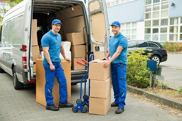 Friendly movers ready to help unload a moving van