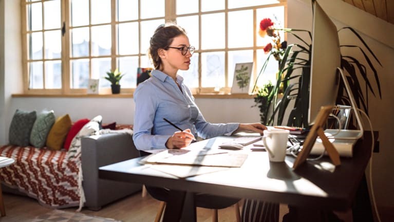 Young woman working from home in a bright apartment